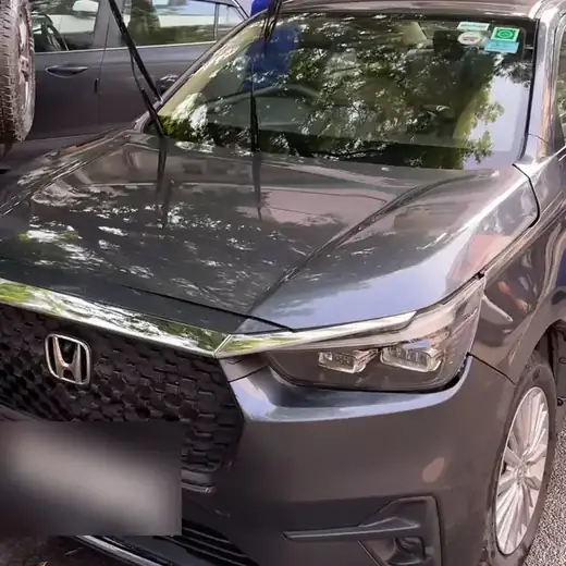 After: the same Honda clean and shining, reflecting the trees